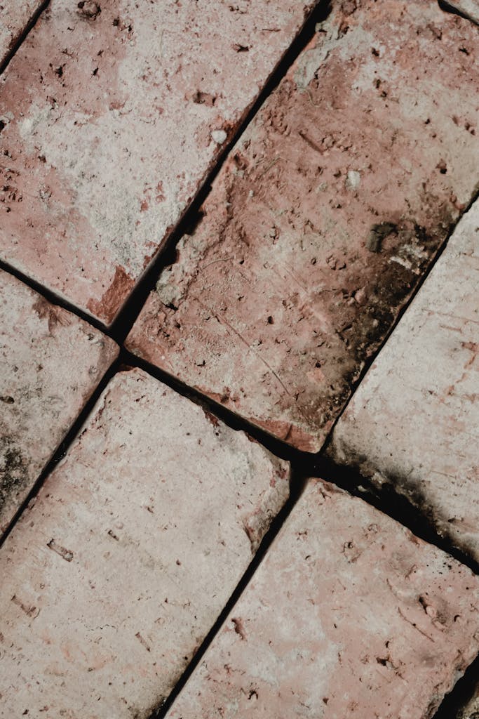 Detailed close-up of a weathered brick wall showing texture and cracks.